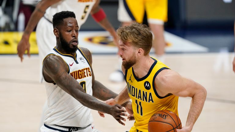 Indiana Pacers forward Domantas Sabonis, right, drives the lane as Denver Nuggets forward JaMychal Green defends in the second half of an NBA basketball game, Monday, March 15, 2021, in Denver. The Nuggets won 121-106.