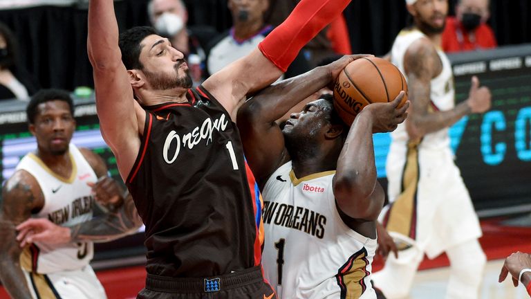 New Orleans Pelicans forward Zion Williamson drives to the basket on Portland Trail Blazers center Enes Kanter, left, during the second half of an NBA basketball game in Portland, Ore., Thursday, March 18, 2021. The Blazers won 101-93. 