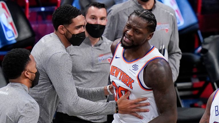 New York Knicks&#39; Julius Randle (30) is restrained by teammates after an NBA basketball game against the Brooklyn Nets, Monday, March 15, 2021, in New York.