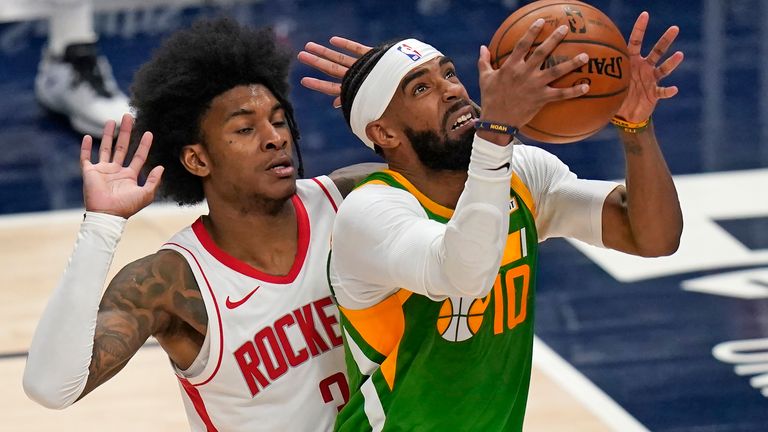 Utah Jazz guard Mike Conley (10) lays the ball up as Houston Rockets guard Kevin Porter Jr. (3) defends during the second half of an NBA basketball game Friday, March 12, 2021, in Salt Lake City. 