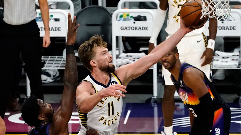 Indiana Pacers forward Domantas Sabonis (11) drives past Phoenix Suns center Deandre Ayton (22) during the first half of an NBA basketball game Saturday, March 13, 2021, in Phoenix. 