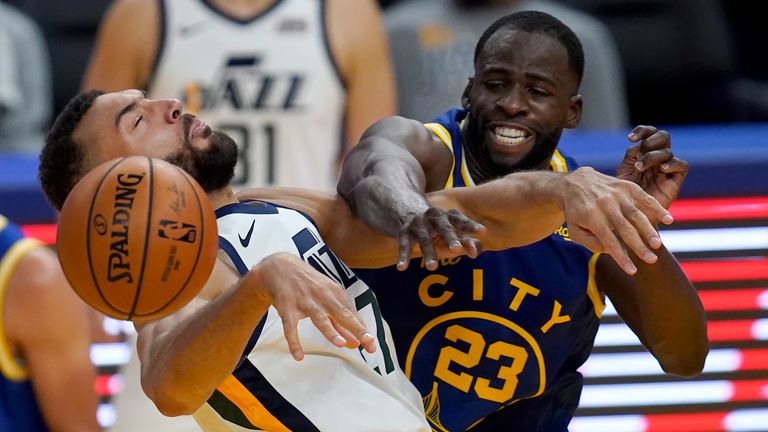 Utah Jazz center Rudy Gobert, left, is fouled by Golden State Warriors forward Draymond Green (23) during the second half of an NBA basketball game in San Francisco, Sunday, March 14, 2021. (AP Photo/Jeff Chiu)