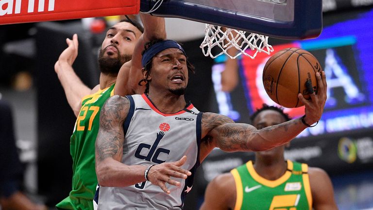 Washington Wizards guard Bradley Beal (3) goes to the basket past Utah Jazz center Rudy Gobert (27) during the second half of an NBA basketball game, Thursday, March 18, 2021, in Washington. 