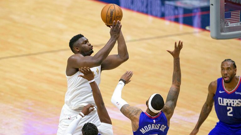 AP - New Orleans Pelicans forward Zion Williamson (1) shoots over  guard Reggie Jackson (1) and forward Marcus Morris Sr. (8) 