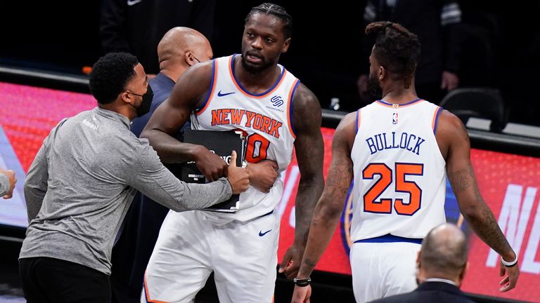 New York Knicks' Julius Randle (30) is restrained by teammates after a late call went against him as they chased down the the Nets