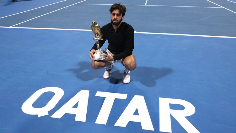 Nikoloz Basilashvili of Georgia poses with the trophy following victory in The Qatar ExxonMobil final between Roberto Bautista Agut and Nikoloz Basilashvili on day six of Qatar ExxonMobil Open 2021
