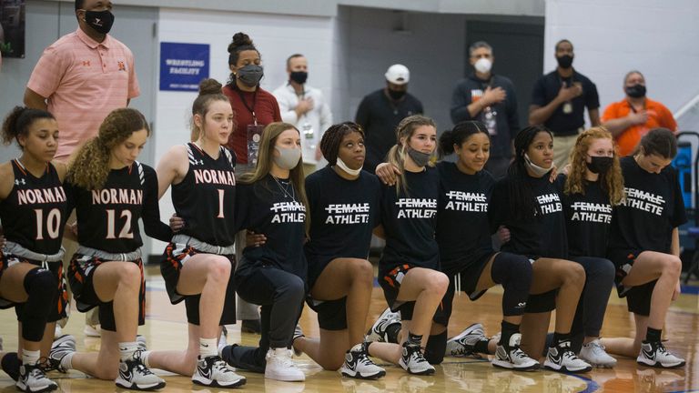 Norman players take the knee during the national anthem before the Class 6A Girls State Basketball Tournament semi-finals on March 12, 2021 in Sapulpa, OK.