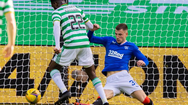 Celtic's Odsonne Edouard is booked for simulation by referee Willie Collum as he goes down under a challenge from Borna Barisic 