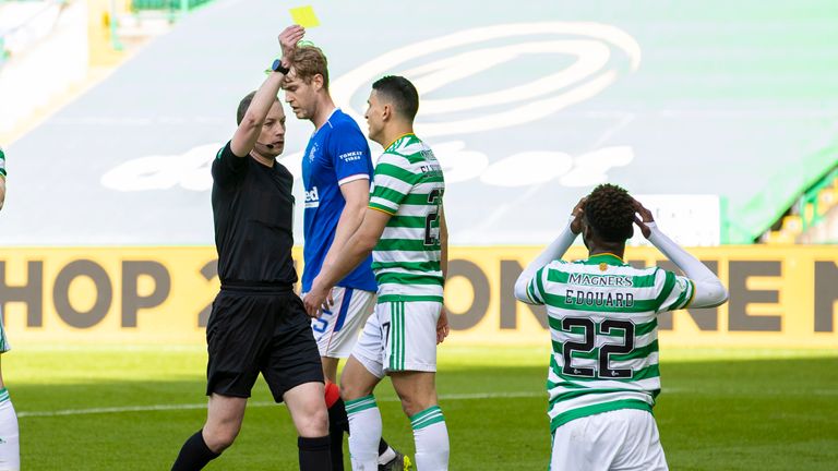 Celtic's Odsonne Edouard is booked for simulation by referee Willie Collum as he goes down under a challenge from Borna Barisic 