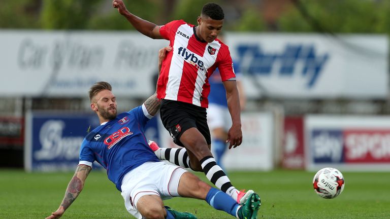 Exeter City's Ollie Watkins (right) and Carlisle United's James Bailey battle for the ball during the Sky Bet League Two play-off second leg at St James Park, Exeter.