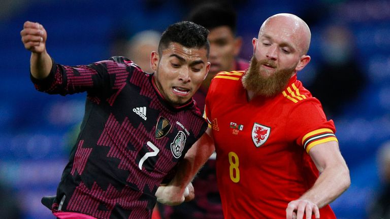 Mexico's Orbelin Pineda, left, and Wales' Jonny Williams battle for the ball