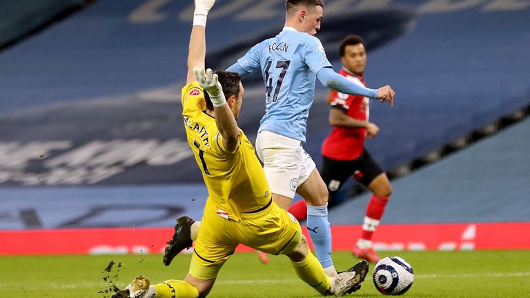 Phil Foden looks to dodge the challenge of McCarthy with the score at 1-1 in the first half