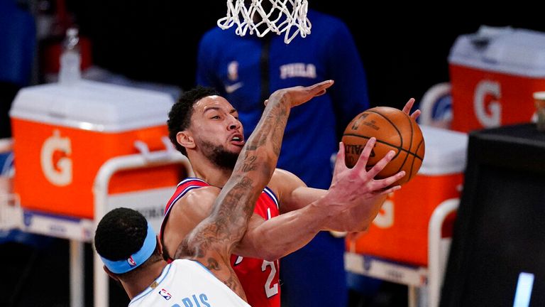 AP - Philadelphia 76ers guard Ben Simmons, top, shoots as Los Angeles Lakers forward Markieff Morris defends