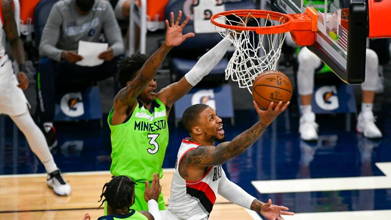 AP - Portland Trail Blazers guard Damian Lillard drives to the basket past Minnesota Timberwolves forward Jaden McDaniels