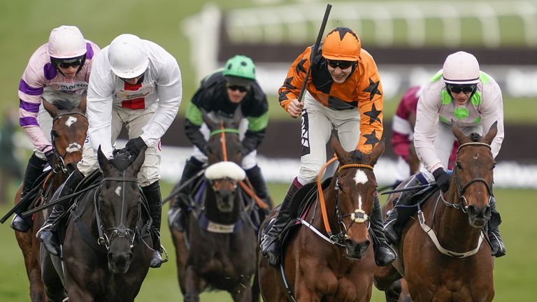 Aidan Coleman riding Put The Kettle On (orange) clears on the way to winning The Betway Queen Mother Champion Chase 
