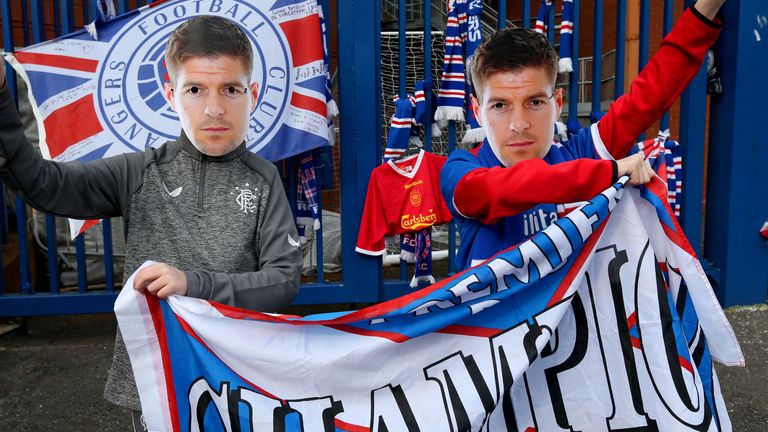 Rangers fans wearing Steven Gerrard masks hold up a banner outside of the Ibrox