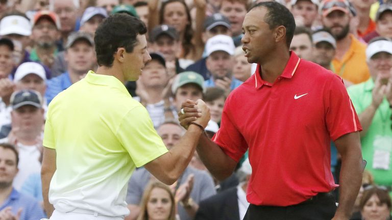 Rory McIlory (L) and Tiger Woods shake hands after finishing the final round of the 2015 Masters 