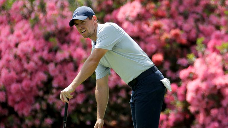 Rory McIlroy, of Northern Ireland, watches his putt on the 13th hole during a practice round for the Masters 