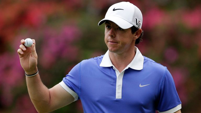 Rory McIlroy, of Northern Ireland, holds up his ball after putting on the 13th green during the first round of the Masters