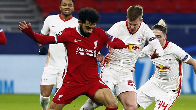 Liverpool's Mohamed Salah and RB Leipzig's Dani Olmo battle for the ball 