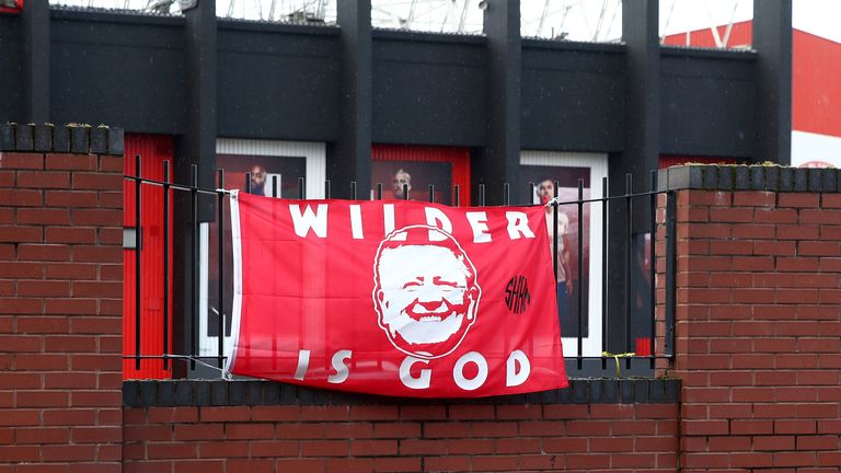 A poster in support of Chris Wilder hangs out Bramall Lane