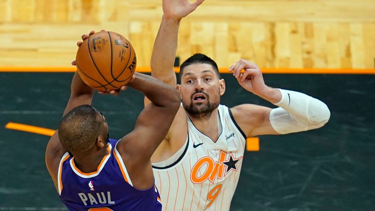 Phoenix Suns guard Chris Paul takes a shot as Orlando Magic center Nikola Vucevic defends