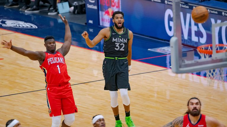 Minnesota Timberwolves center Karl-Anthony Towns watches his shot next to New Orleans Pelicans forward Zion Williamson