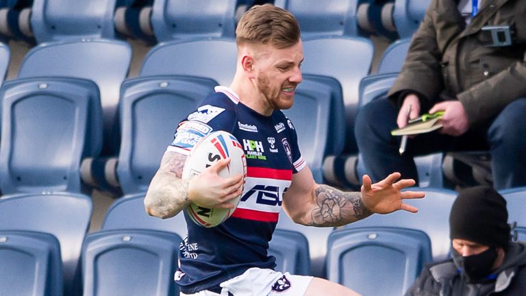 Tom Johnstone evades the tackle of Leeds's Brad Dwyer.