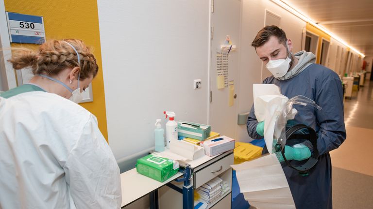 Westerlo's Tuur Dierckx wears protective gear, a face mask and shield, gloves and a suit, during a visit of Westerlo-player Dierckx to the Ziekenhuis Geel hospital and the COVID-ward of the hospital,