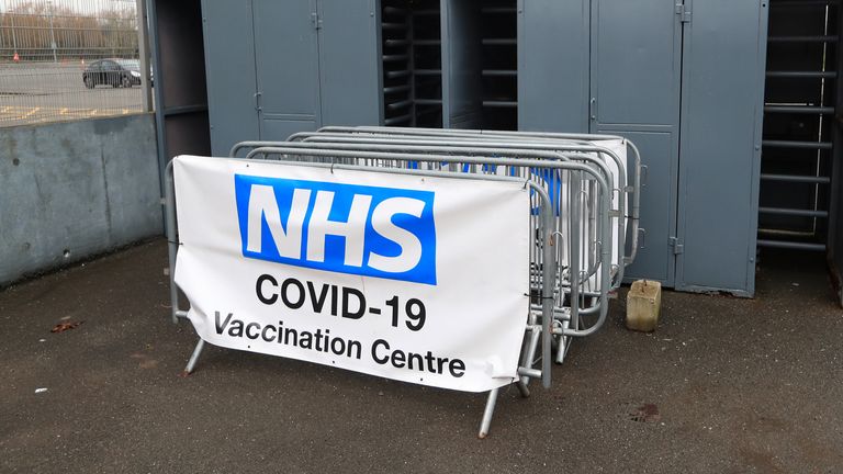 An NHS covid-19 vaccination centre sign at the turnstiles before the Sky Bet League One match at the Pirelli Stadium, Burton.