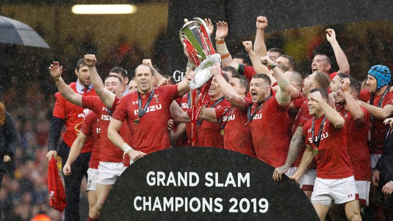 Prince William, at left looks on as the Wales rugby team celebrate with their trophies after winning the Six Nations championships following the international rugby union match between Wales and Ireland at the Millennium stadium in Cardiff, Wales, Saturday, March 16, 2019. Wales have won the Six Nations Championships, known as the Grand Slam, after defeating Ireland in their final game. (AP Photo/Alastair Grant)