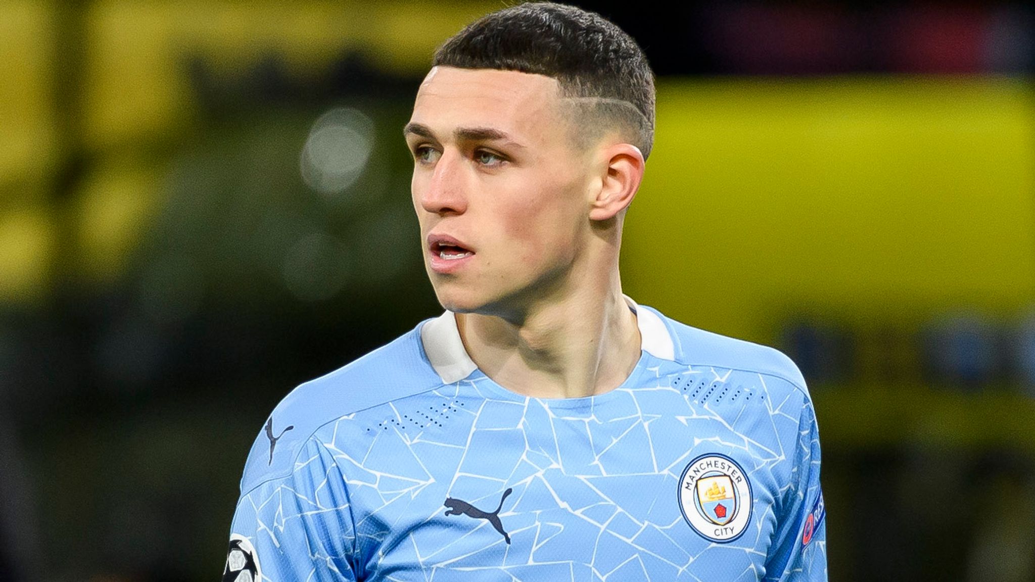  Phil Foden celebrates in front of a Tifo of him on a bus with the words Manchester City.