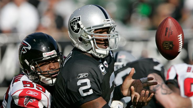 Oakland Raiders quarterback JaMarcus Russell (2) fumbles the ball in front of Atlanta Falcons defensive end John Abraham (55) in the second quarter of their NFL football game in Oakland, Calif., Sunday, Nov. 2, 2008. (AP Photo/Paul Sakuma)