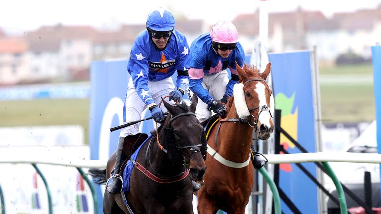 Mighty Thunder ridden by Tom Scudamore (left) wins the Coral Scottish Grand National at Ayr