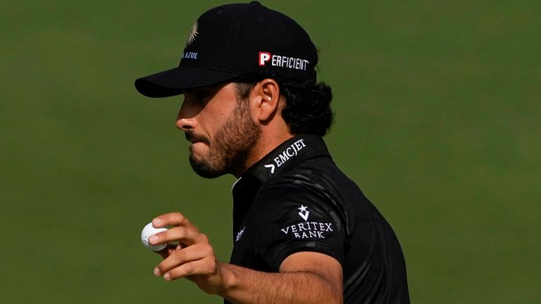 Abraham Ancer, of Mexico, holds up his ball after putting on the second hole during the first round of the Masters golf tournament on Thursday, April 8, 2021, in Augusta, Ga. (AP Photo/Gregory Bull)