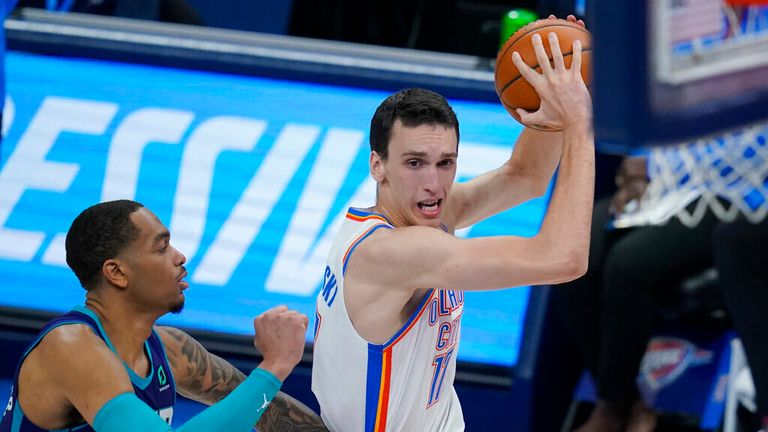 AP - Oklahoma City Thunder forward Aleksej Pokusevski, right, drives around Charlotte Hornets forward P.J. Washington