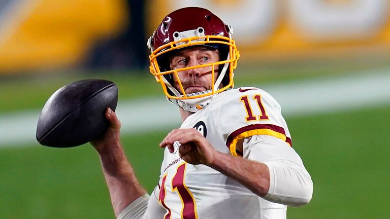 AP -  Washington Football Team quarterback Alex Smith (11) plays in an NFL football game