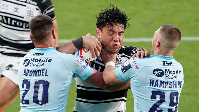 Hull FC's Andre Savelio is tackled by Wakefield Trinity's Joe Arundel (left) and Ryan Hampshire…