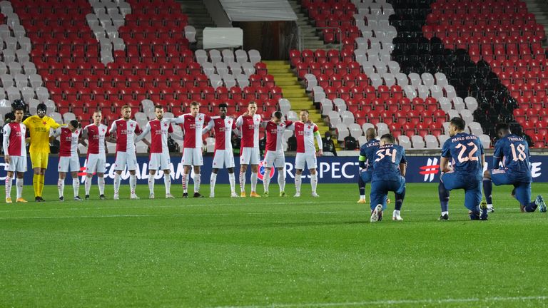 Players of Arsenal takes a knee in support of the Black Lives Matter movement as players of Slavia Praha looks on prior to the UEFA Europa League Quarter Final Second Leg match between Slavia Praha and Arsenal FC at Sinobo Stadium on April 15, 2021 in Prague, Czech Republic. 