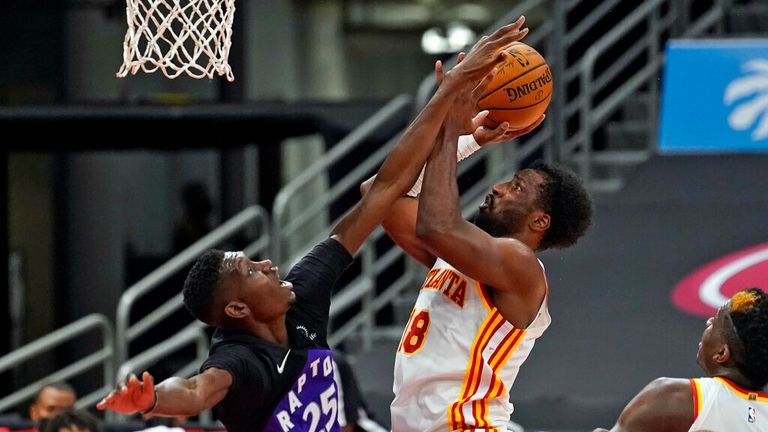 AP - Atlanta Hawks forward Solomon Hill (18) shoots in front of Toronto Raptors forward Chris Boucher (25)