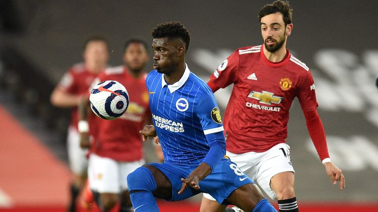 Brighton&#39;s Yves Bissouma, left, and Manchester United&#39;s Bruno Fernandes challenge for the ball during the English Premier League soccer match between Manchester United and Brighton and Hove Albion at Old Trafford, Manchester, England, Sunday, Apr. 4, 2021. (Oli Scarff/Pool via AP)