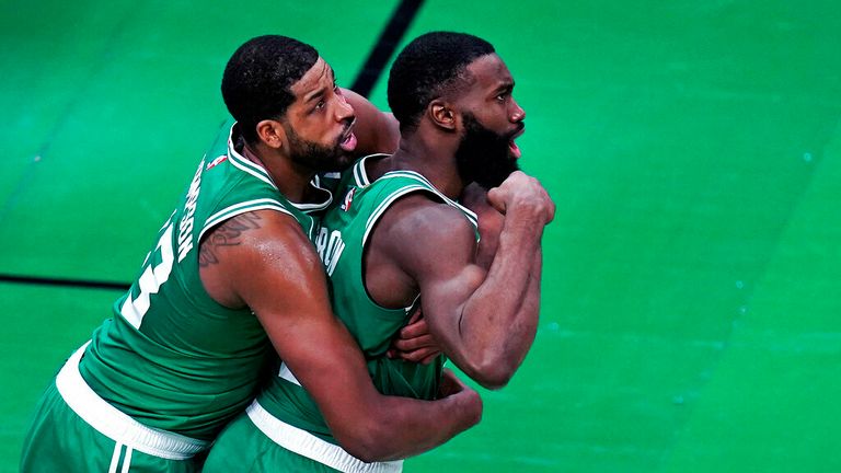 AP - Boston Celtics guard Jaylen Brown, right, flexes after scoring a basket, while being embraced by Tristan Thompson