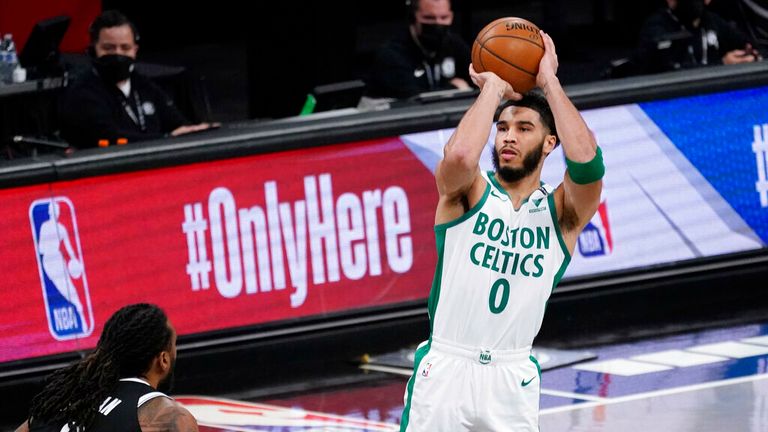 AP - Boston Celtics forward Jayson Tatum (0) shoots a three-point basket past Brooklyn Nets center DeAndre Jordan (6) 