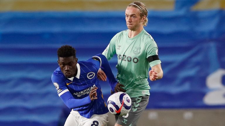 Brighton's Yves Bissouma, left, is challenged by Everton's Tom Davies during the English Premier League soccer match between Brighton and Everton at the Falmer Stadium in Brighton, England, Monday, April 12, 2021. (Paul Childs/Pool via AP)