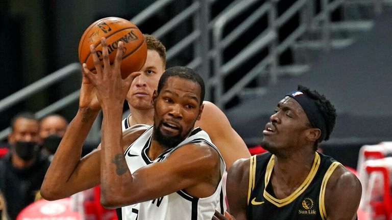 AP - Brooklyn Nets forward Kevin Durant (7) grabs a rebound in front of Toronto Raptors forward Pascal Siakam (43)