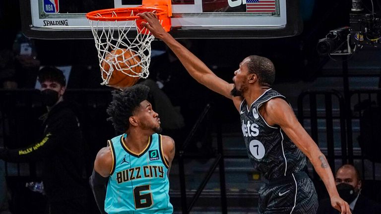 AP - Brooklyn Nets forward Kevin Durant (7) goes to the basket past Charlotte Hornets forward Jalen McDaniels (6)