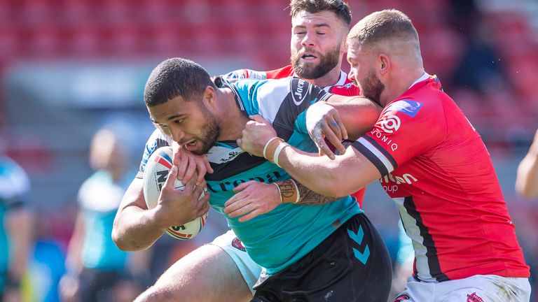 Hull FC's Chris Satae is tackled by Salford's Andy Ackers and Ryan Lannon