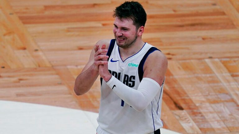 AP - Dallas Mavericks guard Luka Doncic smiles and claps late in the second half