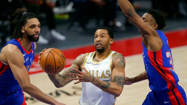 AP - Dallas Mavericks guard Trey Burke, center, drives to the basket against Detroit Pistons center Jahlil Okafor (13) and guard Saben Lee (38) 