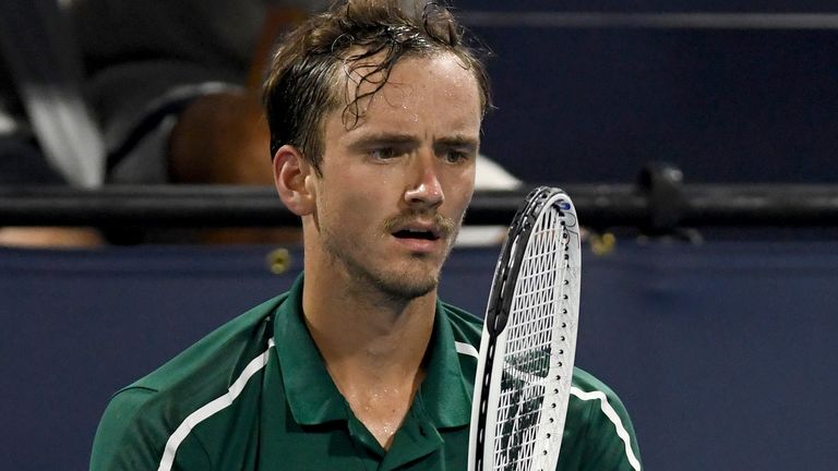 Daniil Medvedev, of Russia, stares at his racket during a break in a match against Roberto Bautista Agut, of Spain, during the Miami Open tennis tournament Wednesday March 31, 2021, in Miami Gardens, Fla. Bautista Agut won 6-4, 6-2. (AP Photo/Taimy Alvarez)